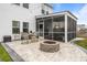 Beautiful backyard with a fire pit, outdoor seating, and a screened porch at 401 Carrara Dr, Summerville, SC 29486