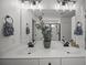 Bathroom featuring dual sinks, modern fixtures, and a plant, with a view of the glass-enclosed shower in the mirror at 401 Carrara Dr, Summerville, SC 29486