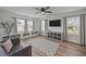 Spacious bonus room with ample natural light, built-in storage, TV, and comfortable seating, perfect for relaxation at 401 Carrara Dr, Summerville, SC 29486
