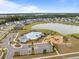 Aerial view featuring a community pool, playground, parking, and a serene lake at 401 Carrara Dr, Summerville, SC 29486