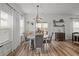 Bright dining area with a round table, stylish chairs, decorative light fixture, and access to the backyard at 401 Carrara Dr, Summerville, SC 29486