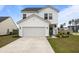 Charming two-story white home featuring a two-car garage and well-maintained landscaping at 401 Carrara Dr, Summerville, SC 29486