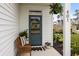 Inviting front porch with a cozy wooden bench, plants, and a 'Welcome Home' doormat at 401 Carrara Dr, Summerville, SC 29486