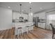 Modern kitchen with a large island, pendant lighting, and stainless steel appliances provides ample workspace at 401 Carrara Dr, Summerville, SC 29486