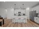 Modern kitchen with a large island, pendant lighting, and stainless steel appliances provides ample workspace at 401 Carrara Dr, Summerville, SC 29486