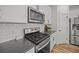 Well-equipped kitchen with stainless steel appliances, a gas cooktop, and sleek white cabinetry at 401 Carrara Dr, Summerville, SC 29486