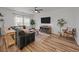 Comfortable living room with a large sectional sofa, ample windows, and a stylish ceiling fan for added comfort at 401 Carrara Dr, Summerville, SC 29486