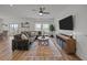 Cozy living room with a large sectional sofa, ample windows, and a stylish ceiling fan for added comfort at 401 Carrara Dr, Summerville, SC 29486