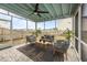 Well-furnished screened porch featuring comfortable seating, a ceiling fan, and outdoor plants at 401 Carrara Dr, Summerville, SC 29486