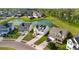 Aerial view of beautiful homes with a pond and landscaping in a quiet neighborhood near lush greenery at 4024 Exploration Rd, Ladson, SC 29456