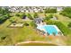 Aerial view of a new construction neighborhood featuring a community pool, playground, and community lake at 4024 Exploration Rd, Ladson, SC 29456