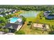 Aerial view of a neighborhood pool, a playground, and a lake surrounded by manicured lawns and lush trees at 4024 Exploration Rd, Ladson, SC 29456
