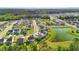Overhead view of the residential area, featuring manicured lawns, a pond, and lush greenery at 4024 Exploration Rd, Ladson, SC 29456