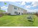 Large backyard with a patio and swing set, offering plenty of space for recreation at 4024 Exploration Rd, Ladson, SC 29456