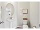 Powder room with pedestal sink, round mirror, and modern fixtures at 4024 Exploration Rd, Ladson, SC 29456