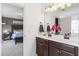 Modern bathroom with double sink vanity and decor with a bedroom featuring a bed and nightstand in the background at 4024 Exploration Rd, Ladson, SC 29456