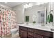 Bathroom with double vanity, bright decor, large mirrors, shower with patterned curtain and plenty of counterspace at 4024 Exploration Rd, Ladson, SC 29456
