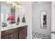 Bright bathroom with double sink vanity, decorative floor tiles, and modern fixtures throughout at 4024 Exploration Rd, Ladson, SC 29456