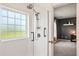 Shower area featuring a tiled shower with a glass door and a view of a bedroom in the background at 4024 Exploration Rd, Ladson, SC 29456
