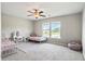 Well-lit bedroom with two beds, a rug, ceiling fan, decor, and natural light from a window overlooking a pond at 4024 Exploration Rd, Ladson, SC 29456