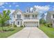 Charming two-story home featuring a two-car garage, a cozy second-story balcony, and a well-kept lawn at 4024 Exploration Rd, Ladson, SC 29456