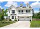 Two-story home featuring a wide driveway, a covered balcony, and a two-car garage at 4024 Exploration Rd, Ladson, SC 29456