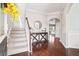 Welcoming foyer features hardwood floors, a staircase, and an elegant console table with decorative accents at 4024 Exploration Rd, Ladson, SC 29456