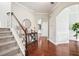Elegant foyer with hardwood floors, staircase, and a stylish console table adorned with decorative elements at 4024 Exploration Rd, Ladson, SC 29456