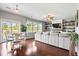 Sunlit living room features hardwood floors, a cozy dining area, and a comfortable sectional sofa with stylish decor at 4024 Exploration Rd, Ladson, SC 29456