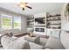 Comfortable living room with hardwood floors, modern fireplace with built-ins, and a plush sectional sofa at 4024 Exploration Rd, Ladson, SC 29456