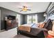 Comfortable main bedroom with dark gray walls, ceiling fan, and a large window for natural light at 4024 Exploration Rd, Ladson, SC 29456