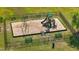 A top down view of a community playground surrounded by green grass, mature trees and several benches at 4024 Exploration Rd, Ladson, SC 29456