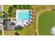 A top down shot of a swimming pool, pool house, a serene lake, and manicured landscaping at 4024 Exploration Rd, Ladson, SC 29456