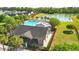 A beautiful community pool is surrounded by palm trees and features a covered pavilion with lake views at 4024 Exploration Rd, Ladson, SC 29456
