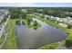 Scenic aerial view showcasing a tranquil community lake surrounded by homes and lush greenery at 404 Forsythia Ave, Summerville, SC 29483