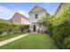 Beautiful backyard features a well-maintained lawn and an inviting patio with a shade umbrella and outdoor seating at 404 Forsythia Ave, Summerville, SC 29483