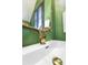 Close up on powder room sink with distinctive gold swan faucet at 404 Forsythia Ave, Summerville, SC 29483