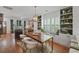Stylish dining area featuring built-in shelving, a modern table with seating for six, and seamless connection to the living room at 404 Forsythia Ave, Summerville, SC 29483