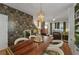 Open dining room features stylish wallpaper, modern lighting fixture, and hardwood floors, creating a warm, inviting atmosphere at 404 Forsythia Ave, Summerville, SC 29483