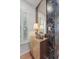 Entryway with patterned wallpaper, a stylish wood cabinet and matching gold mirror at 404 Forsythia Ave, Summerville, SC 29483