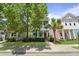 Charming multi-story homes with inviting front porches, manicured lawns and attractive landscaping creating a vibrant neighborhood street view at 404 Forsythia Ave, Summerville, SC 29483