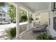 Inviting front porch with chaise lounge, ferns, fresh landscaping, and view of neighborhood at 404 Forsythia Ave, Summerville, SC 29483