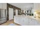 Open kitchen with stainless steel appliances and a marble island, connecting the dining and living spaces, offering great flow at 404 Forsythia Ave, Summerville, SC 29483