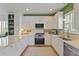 Well-lit kitchen features white cabinets, stainless steel appliances, marble countertops, and modern fixtures, a culinary dream at 404 Forsythia Ave, Summerville, SC 29483