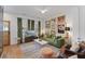 Bright and airy living room featuring an eclectic gallery wall, comfortable green velvet sofa and a stylish accent rug at 404 Forsythia Ave, Summerville, SC 29483
