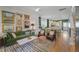 Airy living room featuring an eclectic gallery wall, comfortable green velvet sofa and open layout to a dining area and kitchen at 404 Forsythia Ave, Summerville, SC 29483