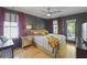 Bedroom with dark gray walls, a ceiling fan, and access to a private balcony at 404 Forsythia Ave, Summerville, SC 29483