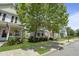 A street view featuring colorful homes with inviting front porches and well-manicured lawns at 404 Forsythia Ave, Summerville, SC 29483