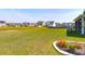 Expansive backyard with lush green grass, a pond, and flower beds creating a serene outdoor space at 408 Trevi Ln, Summerville, SC 29486