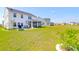 Large backyard showcasing the house, patio, grill, lawn, and serene water view at 408 Trevi Ln, Summerville, SC 29486
